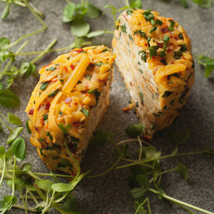 Image of cheddar chilly chives each, a blend of soft and hard cheese with spiced undertone. 