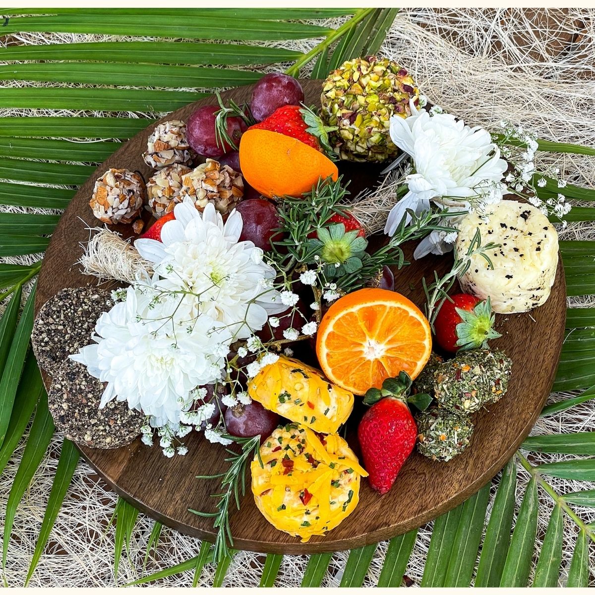 Image of six cheese on a platter, including delicious cheese flavours, a ready to eat beautifully decorated cheese board with grapes and flowers 