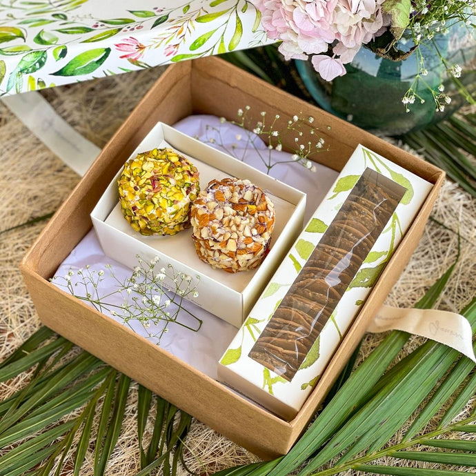 An image of a gift hamper including two cheese flavours and a mixed cracker box. A perfect gift for a birthday, housewarming, or dinner party