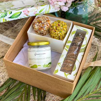 An image of a gift hamper including two cheese flavours, Mediterranean spreads, and a mixed cracker box. A perfect gift for a birthday, housewarming, or dinner party.