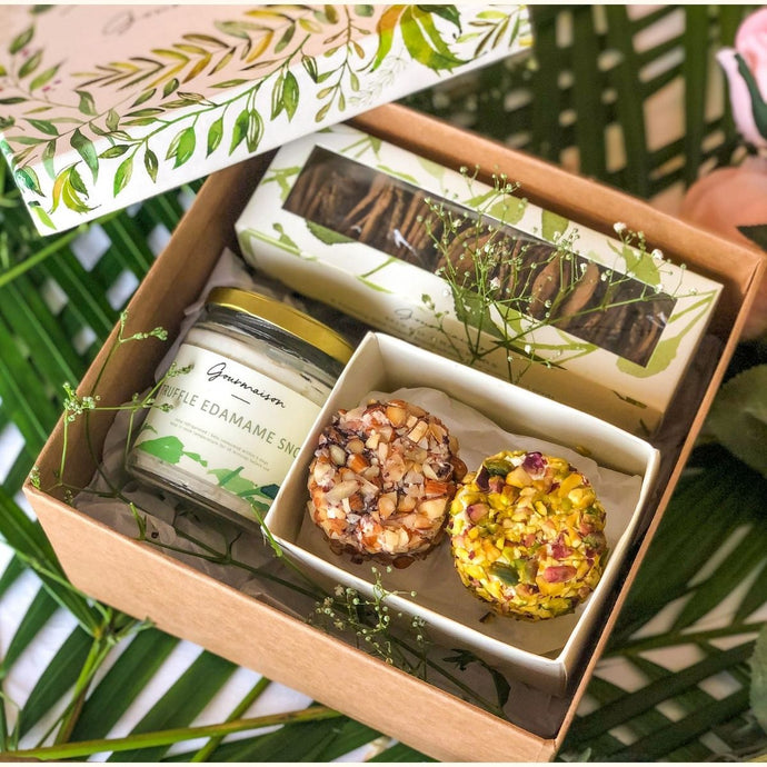 An image of a gift hamper including two cheese flavours, a truffle edamame cheese spread, and a mixed cracker box. A perfect gift for a birthday, housewarming, or dinner party.